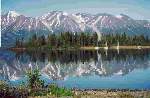 Reflections of boats and mountains